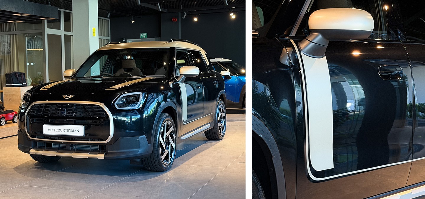 Side rear view of the MINI Countryman in Nanuq White with Black Roof standing on a street.